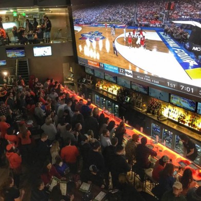 People watching a basketball game at (716) Food & Sport