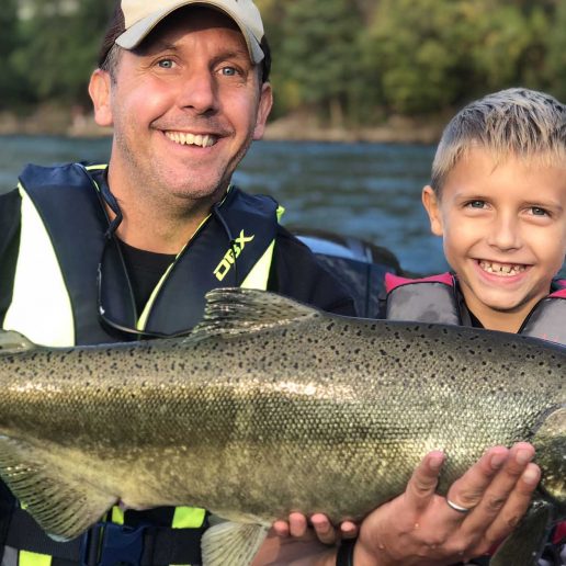 Father and son holding a caught fish